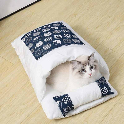 cat using a blue sleeping bag
