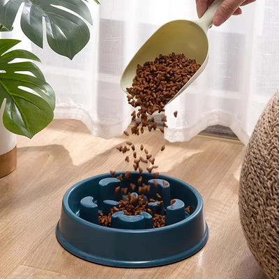pouring dog food into a slow feeder bowl