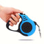 hand holding a blue retractable dog leash