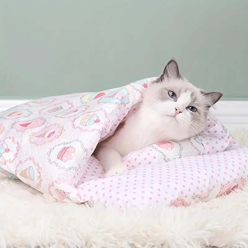 cat inside a pink sleeping bag