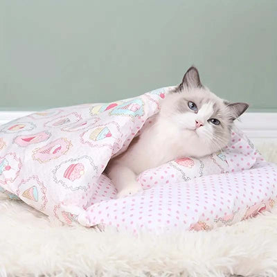 cat inside a pink sleeping bag